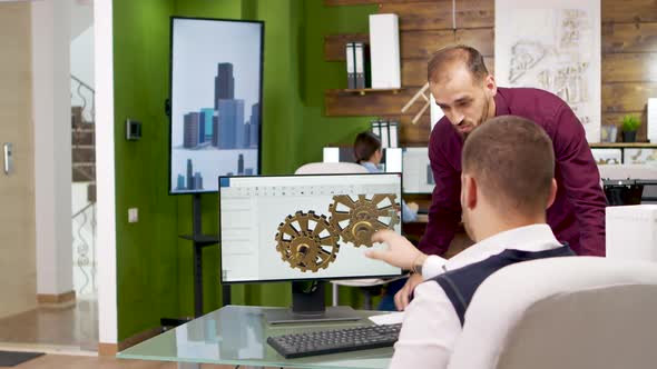 Team of Creative Architects Working on Computer alt
