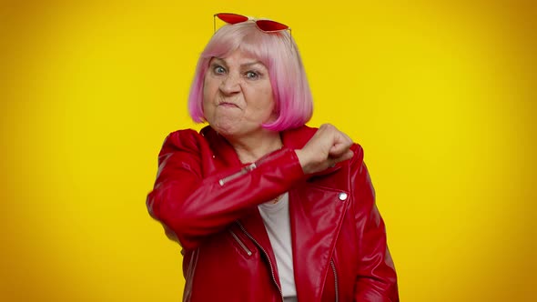 Aggressive Angry Senior Granny Woman Trying to Fight at Camera Shaking Fist Boxing Punishment alt