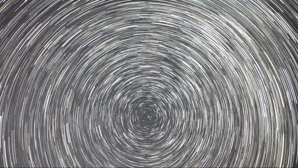 Timelapse of moving star trails in night sky. The Milky Way galaxy rotating