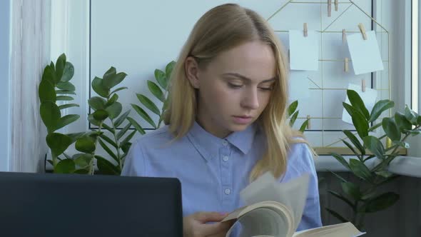Young Female Teacher Sitting at Desk and Using Laptop at Home alt