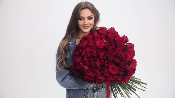 Attractive Woman Going to Camera with Bouquet of Red Roses