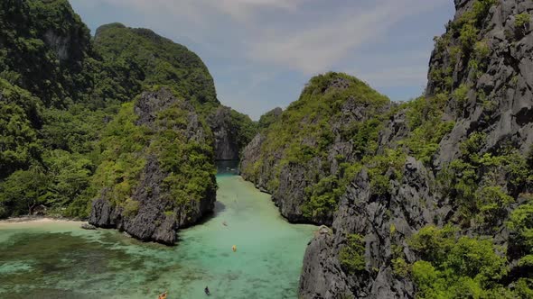 beautiful aerial drone shot of big lagoon entrance in midle of limestone cliffs in el nido palawan p alt