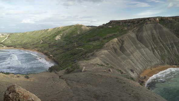 Walking Between Qarraba and Ghajn Tuffieha Bays with Steep Slopes of Hill Leading Down to Beaches alt