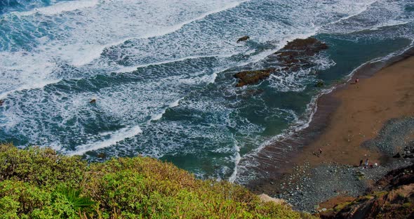 Rocks in the Sea  Atlantic Ocean Waves with Foam and Giant Rock Formations in the Background alt