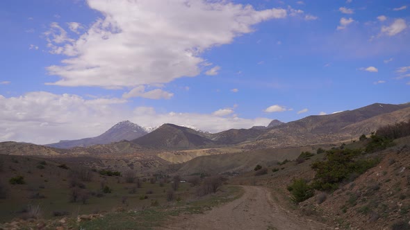 Time lapse of cloud shadows as low cloudse over mountainous terrain alt