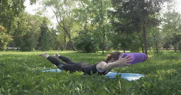 Beautiful Woman Doing Pilates in the Green Park