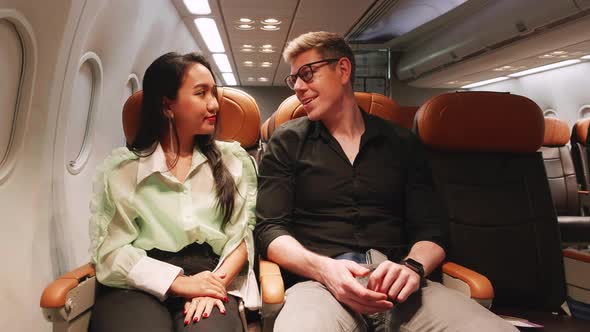 young couple in love traveling in airplane, Talking and fun, honeymoon sweet travel trip