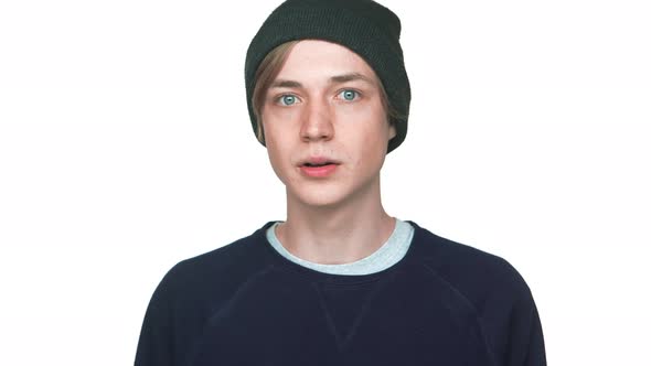 Portrait of Blueeyed Teenager in Hat with Clean Skin Being Surprised Shocked with Opened Mouth Over alt