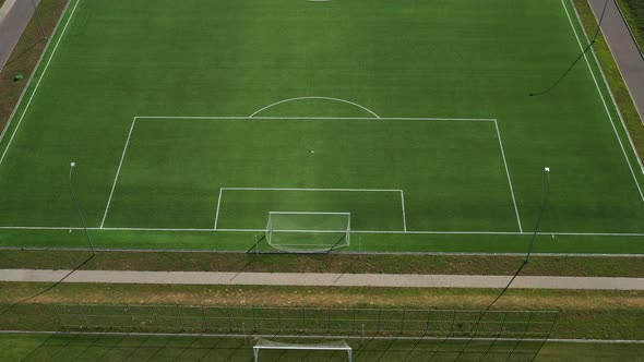 Top View of a Football Field with Green Grass Outdoors in Summer