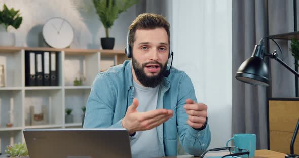 Male Blogger with Stylish Beard in Headset Recording Lifestyle Vblog for His Followers alt