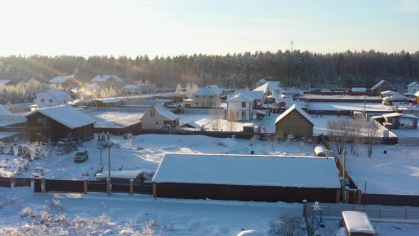 A Small Village in the Middle of a Pine Forest in Winter After Snowfall on a Bright Sunny Day