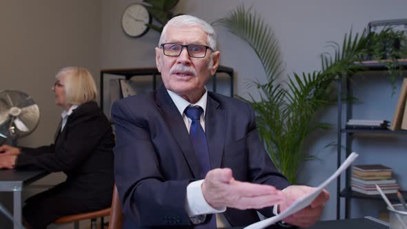 Senior Man Boss Dissatisfied with Bad Results of Work Reviewing Report and Documents with Errors alt