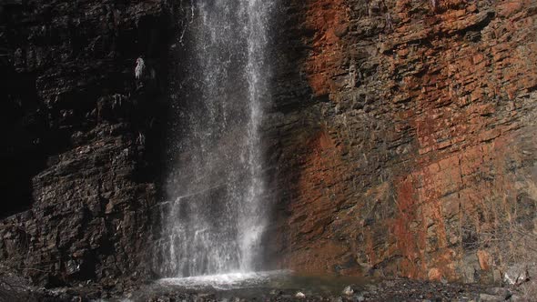 Slow rising view flowing up waterfall alt