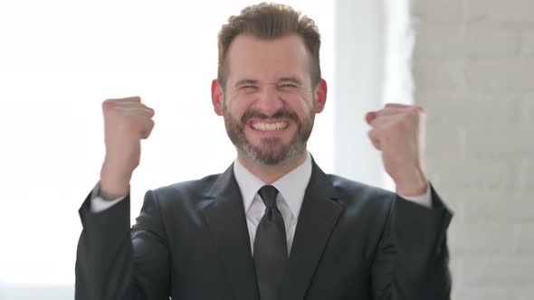 Excited Middle Aged Businessman Celebrating Success alt