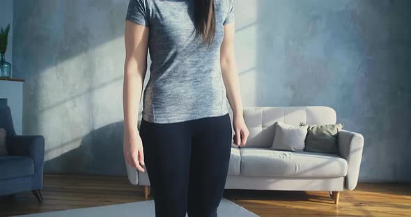 Woman Stands on Scales Becoming Sad of Weight in Room alt