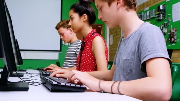 Students studying on computer in classroom alt