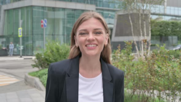 Young Businesswoman Talking on Online Video Call While Walking on the Street alt