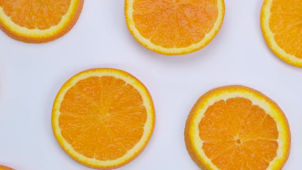 Rotating Background with Slides of Orange on a White Background Trendy Summer Fruity Background
