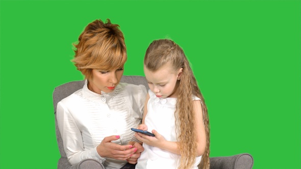 Mmother and child playing game on the smartphone