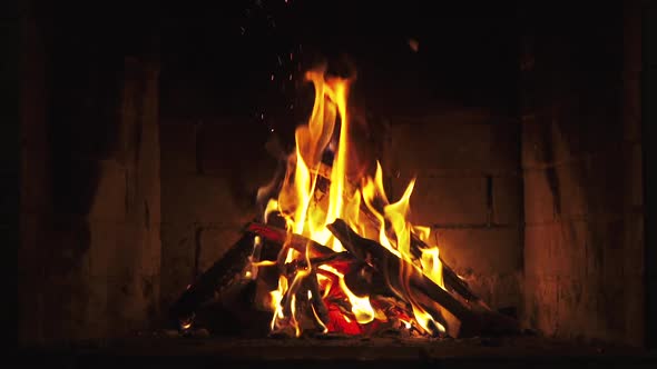 A Looping Clip of a Fireplace with Medium Size Flames Burning Fire Slow Motion.  alt
