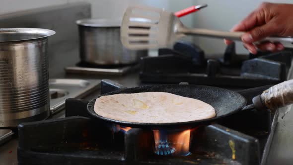 Preparing Indian Aloo Paratha in a Frying Pan.