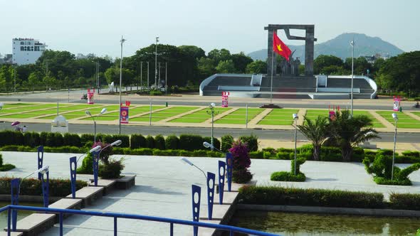 Static shot of April Park Monument and Vietnamese flag. Phan Rang center alt