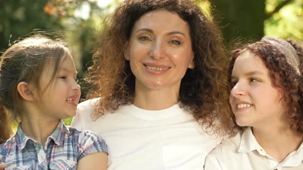 Happy Woman with Two Daughters of Different Ages