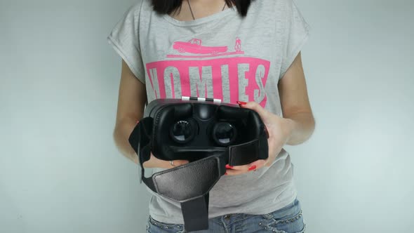 Girl Is Examining The Helmet Of Virtual Reality