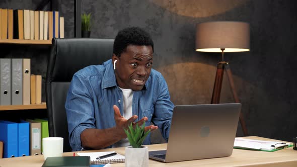 Excited African American Man Looks at Laptop Celebrates Financial Market Growth alt