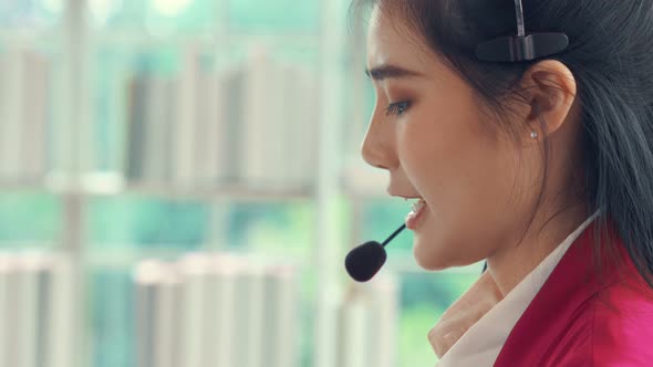 Businesswoman Wearing Headset Working Actively in Office alt