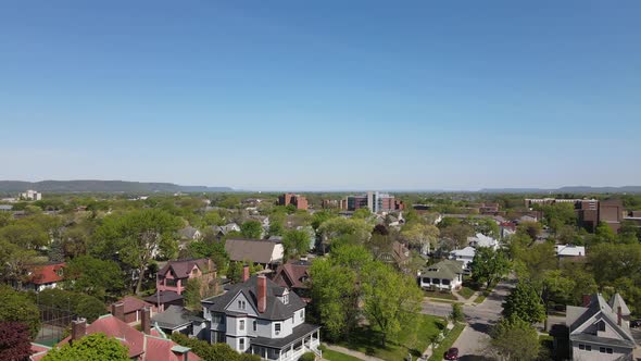 Drone view over well established midwest city on a bright summer day with a clear sky.