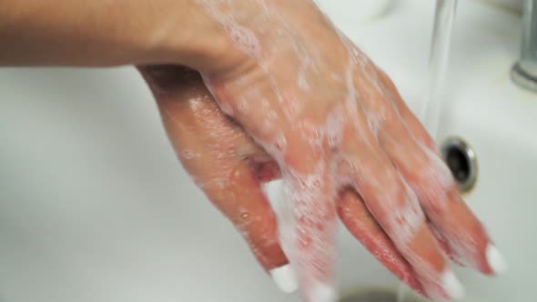 hand of beauty woman wash your hands at the wash basin with foam, cleanse the skin alt