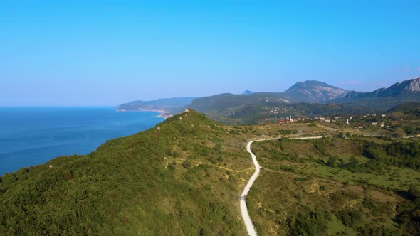 steep green mountains, deep forest and mountain road, beautiful valley and blue sea alt