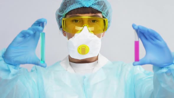 Biotechnologist in Protection Suit Showing Reagents and Analyzing Them alt