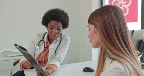 Close Up Portrait of Young Pretty African American Doctor at Workplace Speaking alt