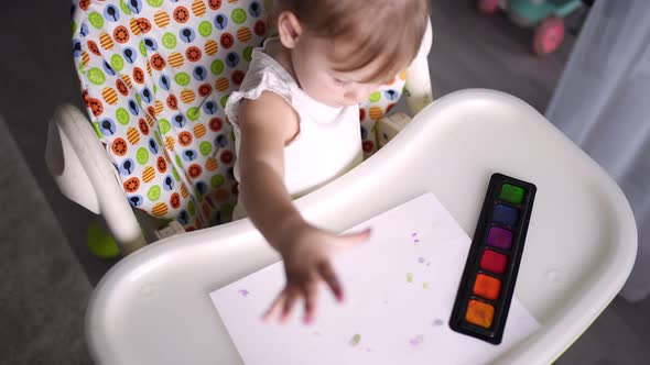 Cute Little Girl Painting with Fingers at Home alt