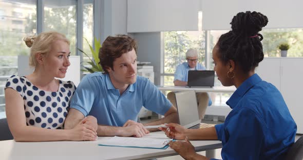 African Woman Bank Manager in Office Consulting Young Married Couple alt