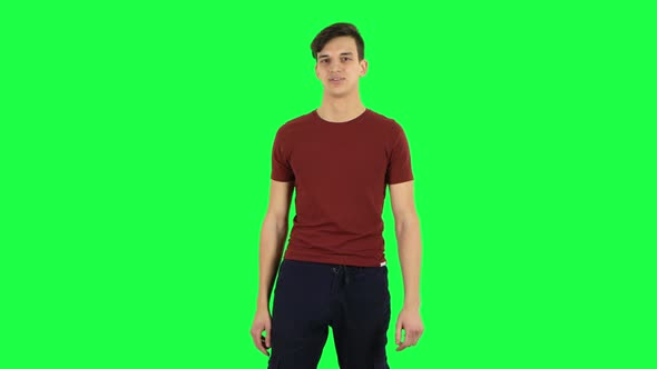 Guy Listens Attentively and Nods His Head Pointing Finger at Viewer. Green Screen alt