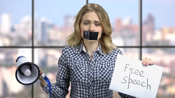 Upset Woman with Mouth Taped Shut. alt