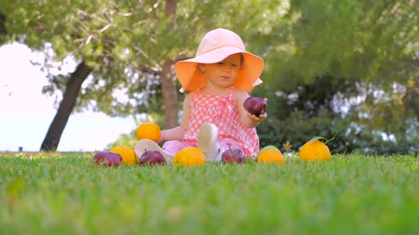 Little Princess Playing with Fruits Outdoor. Child in Panama Having Fun Outdoor on Back Yard. Happy