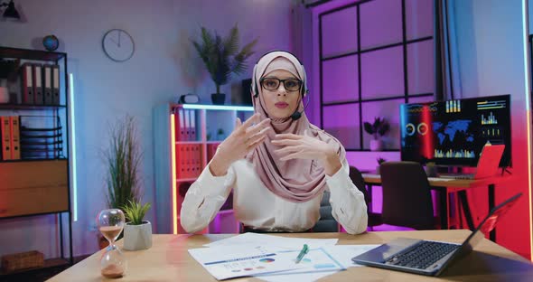 Businesswoman in Hijab which Wearing Headset During Recording Video for Internet Channel alt