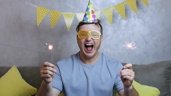 Smiling Man Celebrates His Birthday. A Very Happy Young Man Celebrates His Birthday alt