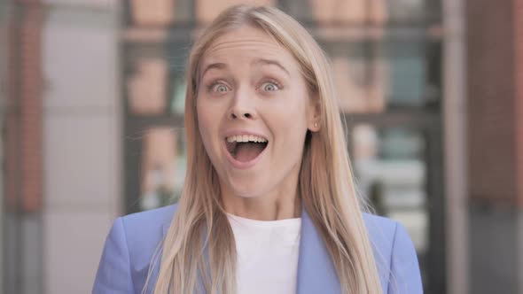 Blonde Businesswoman Surprised by Results alt