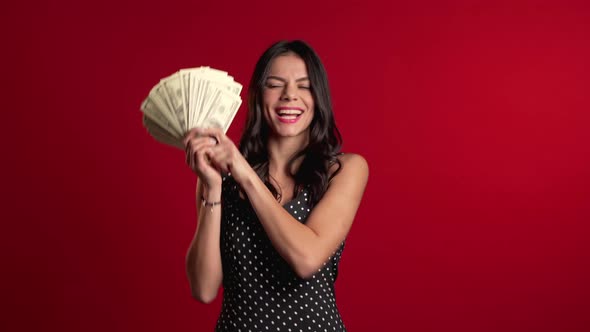 Satisfied Happy Excited Latin Girl Showing Money - U.S.dollars Banknotes on Red  alt