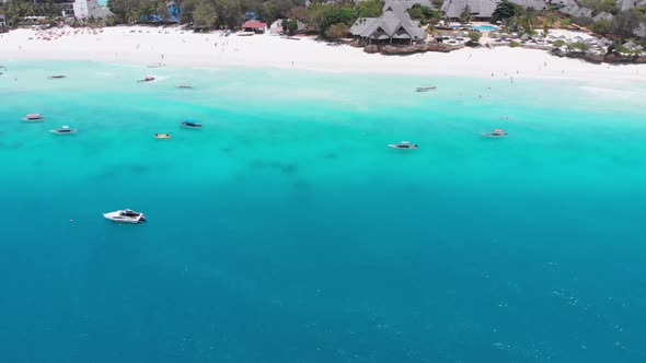 Exotic Sandy Beach with Turquoise Ocean Boats and Hotels Zanzibar Aerial View alt