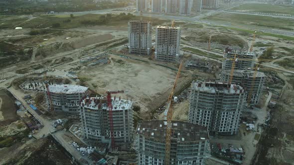 Construction site of a modern city block. High-rise buildings under construction. alt