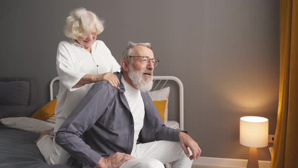 An Elderly Couple Takes Care of Each Other a Wife Massages Her Adult Spouse