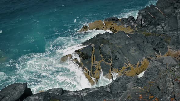 Waves Breaking over Big Rocks on Coastal Landscape alt