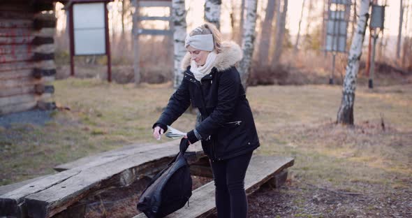 Female Tourist Taking a Brake During Walk in Mountains alt