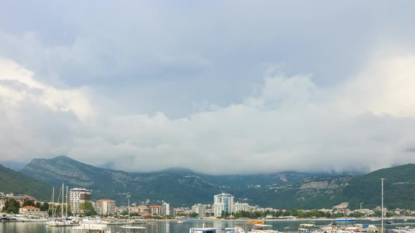Time lapse, clouds moving over the Budva city and mountains, Adriatic sea coastline in Montenegro